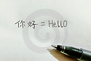 The neat handwriting of Ã¢â¬ÅHelloÃ¢â¬Â in Chinese and English characters, closeup of homework of a beginner Chinese language learner photo